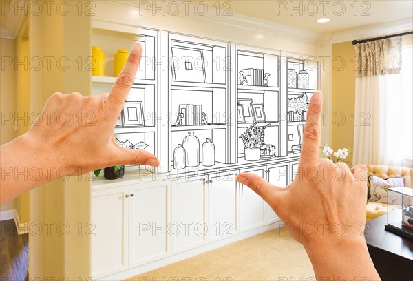 Hands framing custom built-in shelves and cabinets design drawing with section of finished photo