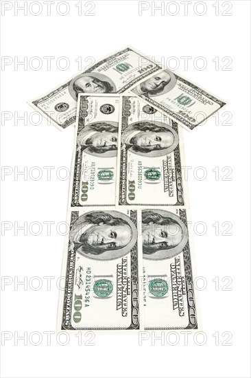 Arrow made of dollars isolated on white