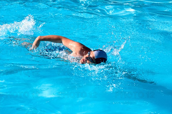 Athletic Man swimming in the pool