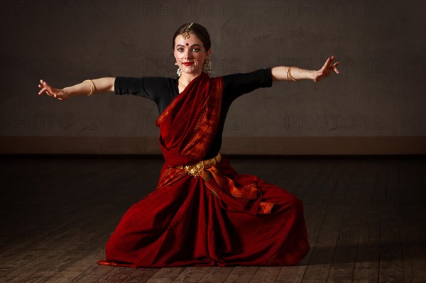 Young woman in sary dancing classical traditional indian dance Bharat Natyam