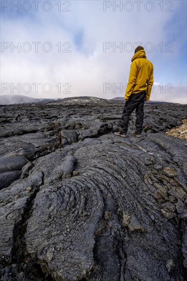 Tourist standing on petrified lava