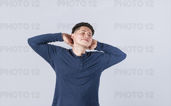 Relaxed man with closed eyes with hands behind his head