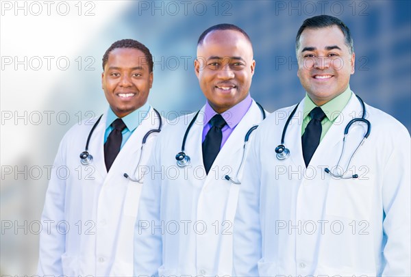 Handsome african american and hispanic male doctors outside of hospital building