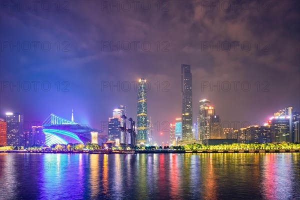 Guangzhou cityscape skyline over the Pearl River illuminated in the evening. Guangzhou