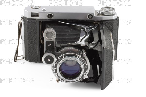 Old folding camera isolated on white background