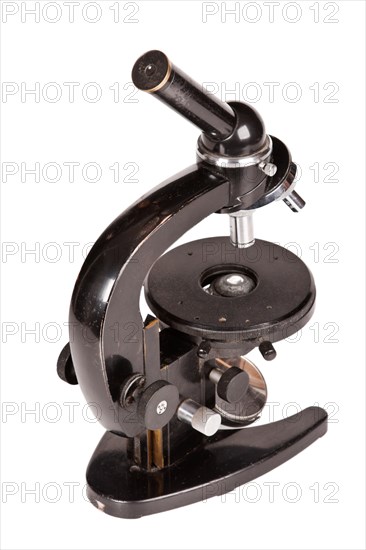 Old microscope isolated on white background