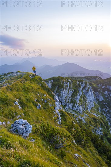 Hikers at the summit of the Benediktenwand at sunset