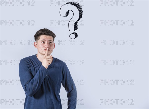 Thoughtful young man looking up with exclamation marks