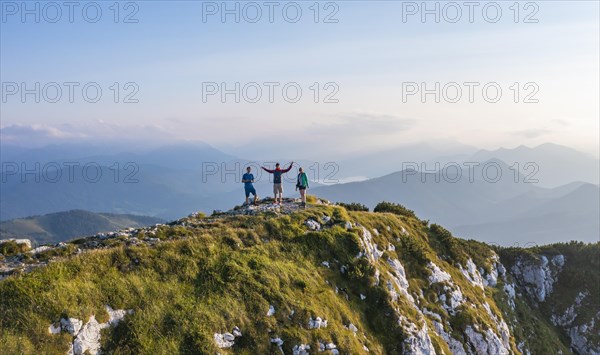 Three hikers at the summit