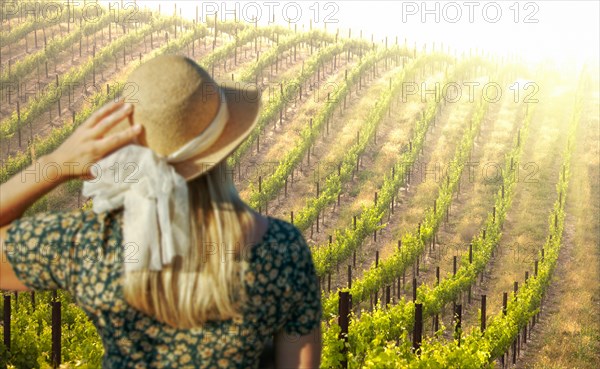 Beautiful woman strolling at a winery on a spring day