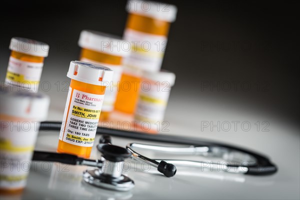 Several non-proprietary medicine prescription bottles abstract with stethiscope