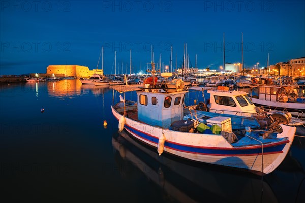 Venetian Fort Venetian fortress of Koules Castello a Mare castle in Heraklion and moored Greek fishing boats in port