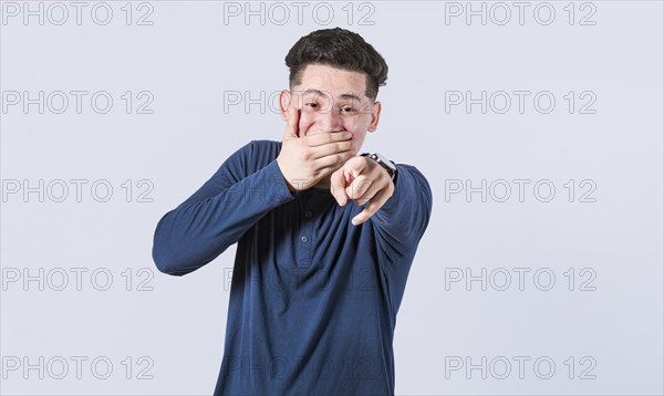 Isolated attractive guy laughing at you