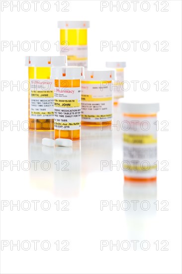 Non-Proprietary medicine prescription bottles and pills isolated on a white background