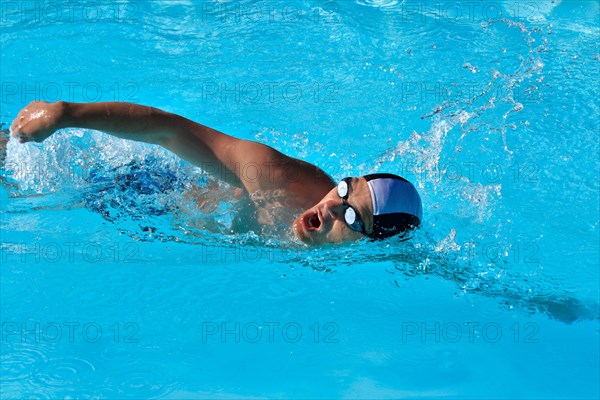 Athletic Man swimming in the pool