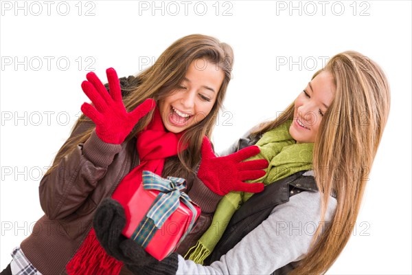 mixed-race young adult females holding A christmas gift isolated on a white background