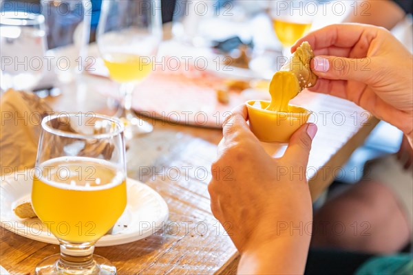 Woman enjoys warm pretzels and micro brew beer