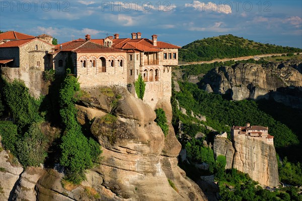 Monastery of Varlaam monastery and Monastery of Rousanou in famous greek tourist destination Meteora in Greece on sunset with scenic scenery landscape