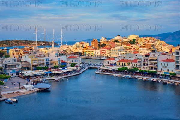 Beautiful Agios Nikolaos town on lake Voulismeni on sunset. Lasithi region of Crete island