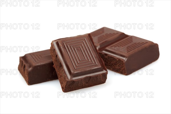 Pieces of dark chocolate isolated on white background