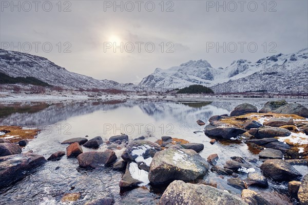 Sunset in Norwegian fjord in winter. Lofoten islands