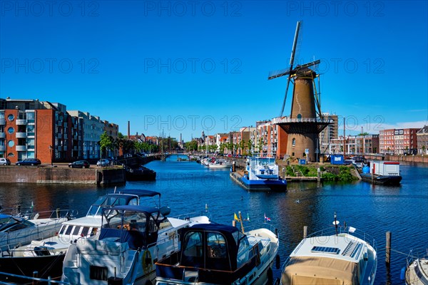 View of the harbour of Delfshaven with the old grain mill known as De Destilleerketel