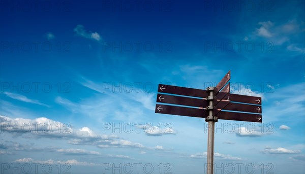 Blank signpost in sky with clouds