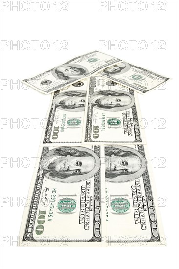 Arrow made of dollars isolated on white