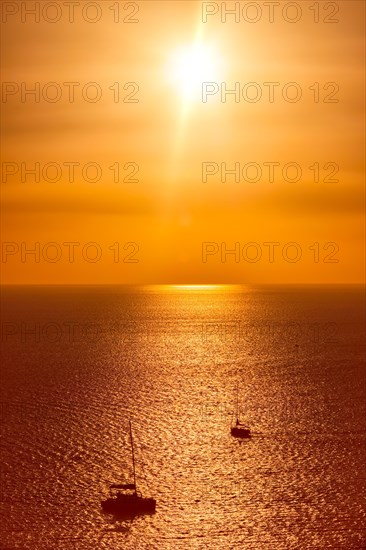 Yacht boats silhouettes in Aegean sea on sunset. Mykonos