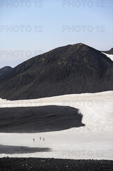 Hikers in the distance on a snow field