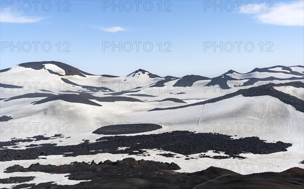 Barren hilly volcanic landscape of snow and lava fields