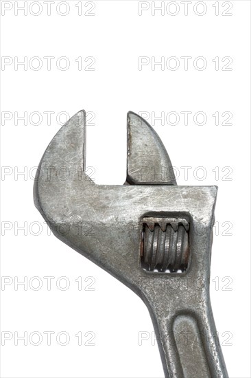 Old adjustable spanner isolated on white background
