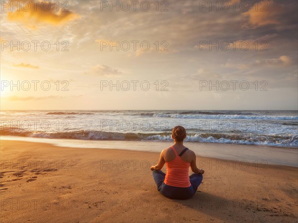 Young sporty fit woman doing yoga