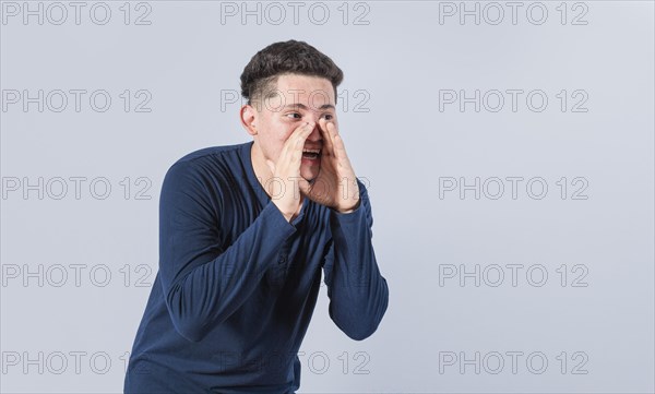 Handsome man shouting an announcement