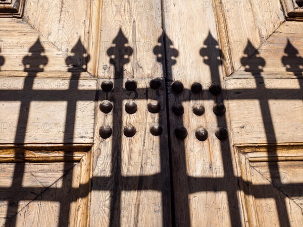 Shadow from a fence at the church gate