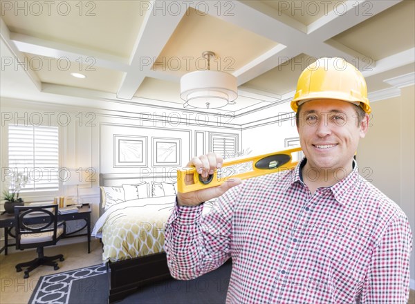 Smiling contractor in hard hat with level over custom bedroom drawing and photo combination