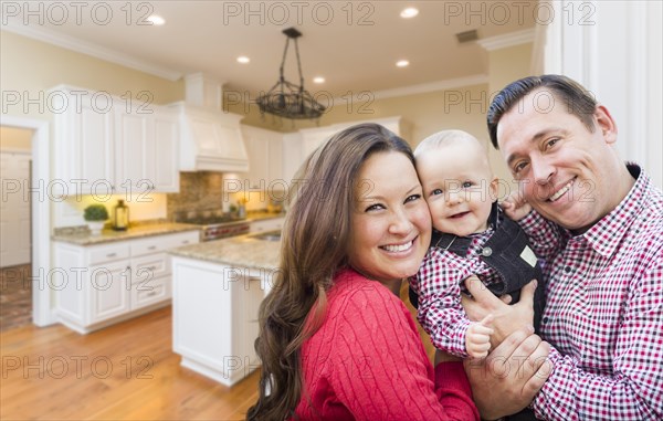 Young happy family inside beautiful custom kitchen
