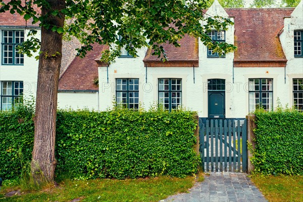 Old houses and garden of Begijnhof Beguinage in Bruges town