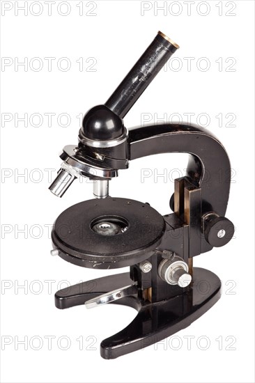 Old microscope isolated on white background