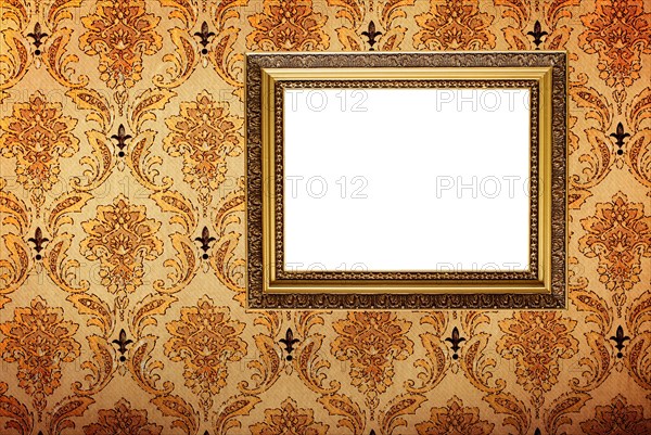 Vintage gold plated picture frame on retro wallpaper background