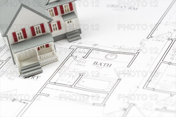 Model house resting on custom house plans