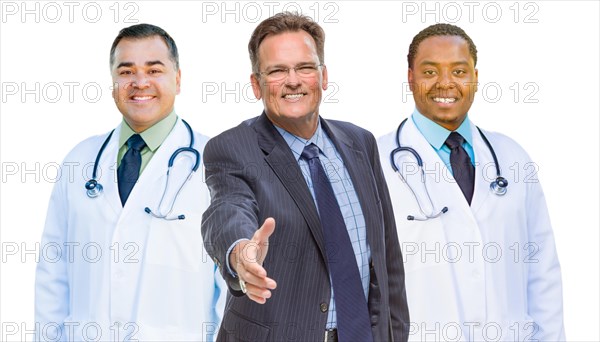 Two mixed-race doctors behind businessman reaching for a hand shake isolated on white