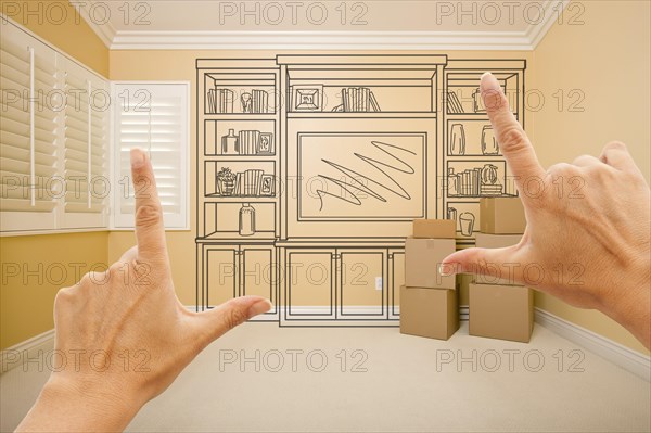 Framing hands of shelf design drawing on wall in empty room