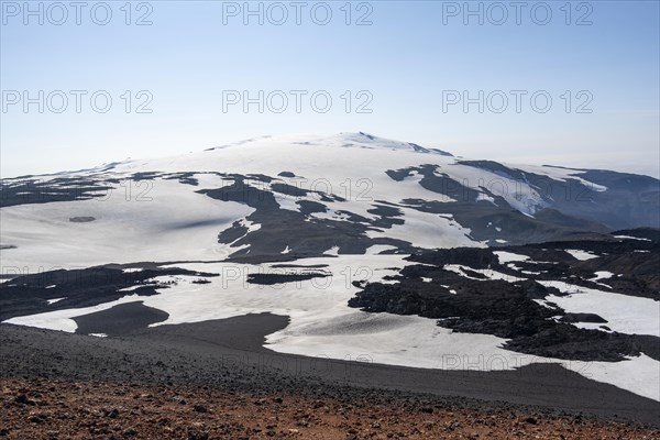 Barren hilly volcanic landscape of snow and lava fields