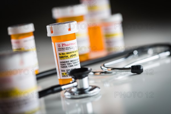 Several non-proprietary medicine prescription bottles abstract with stethoscope