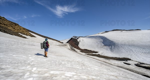 Hikers on the Fimmvoerouhals trail on a snowfield