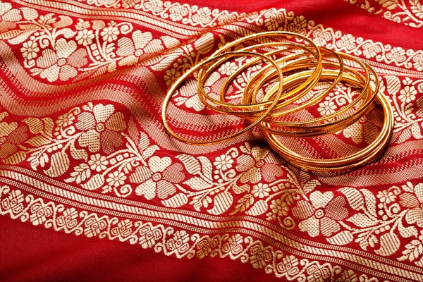 Indian sari with golden bangles clouse up