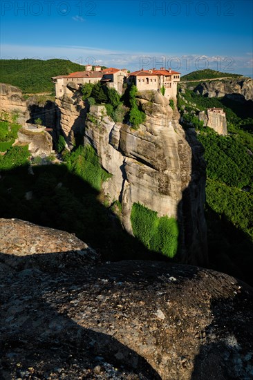 Monastery of Varlaam monastery and Monastery of Rousanou in famous greek tourist destination Meteora in Greece on sunset with scenic scenery landscape