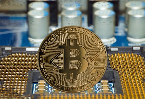A Bitcoin stands on a motherboard