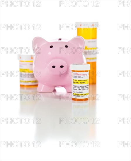 Piggy bank and non-proprietary medicine prescription bottles isolated on a white background
